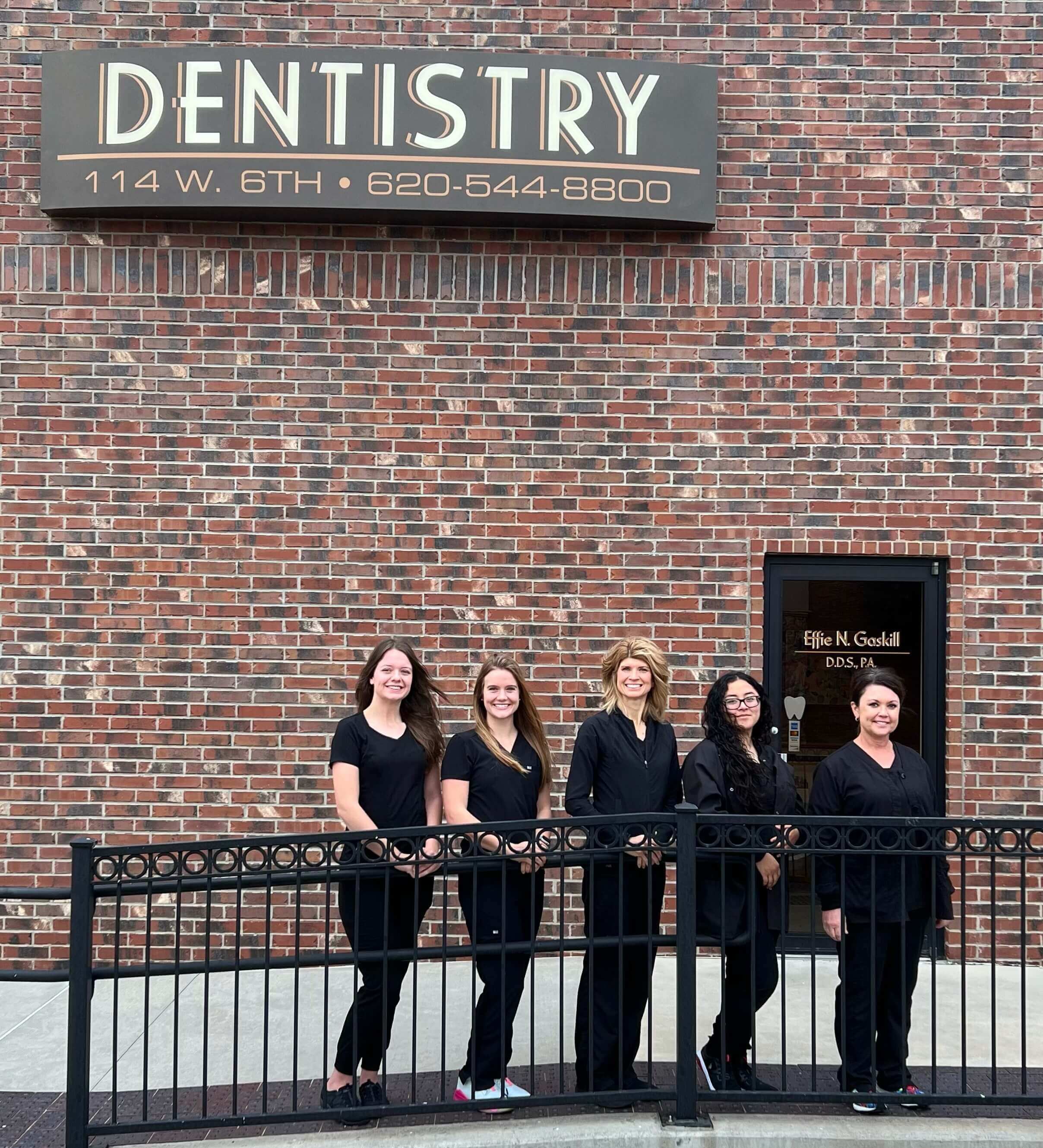 Dr. Effie Gaskill & employees in front of dentist office 